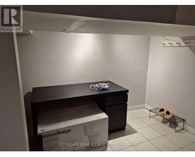 A room with a black desk and a box of WaterRidge.