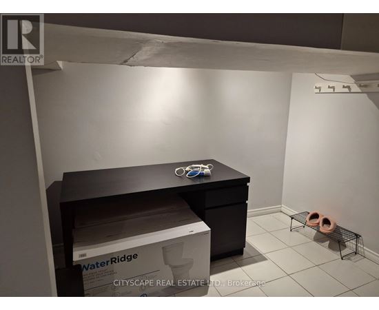 A room with a black desk and a box of WaterRidge.