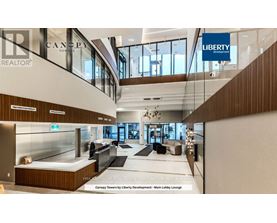A lobby lounge with a glass wall and a sign that says "Canopy Towers by Liberty Development".