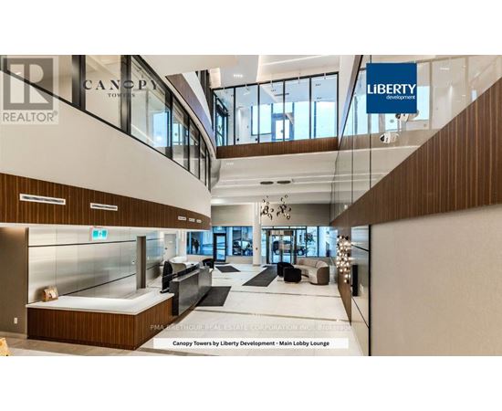 A lobby lounge with a glass wall and a sign that says "Canopy Towers by Liberty Development".