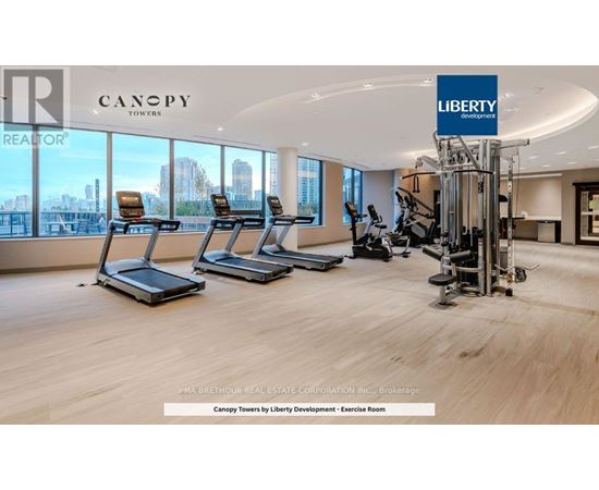 A gym with treadmills and exercise equipment in a Canopy Towers office.