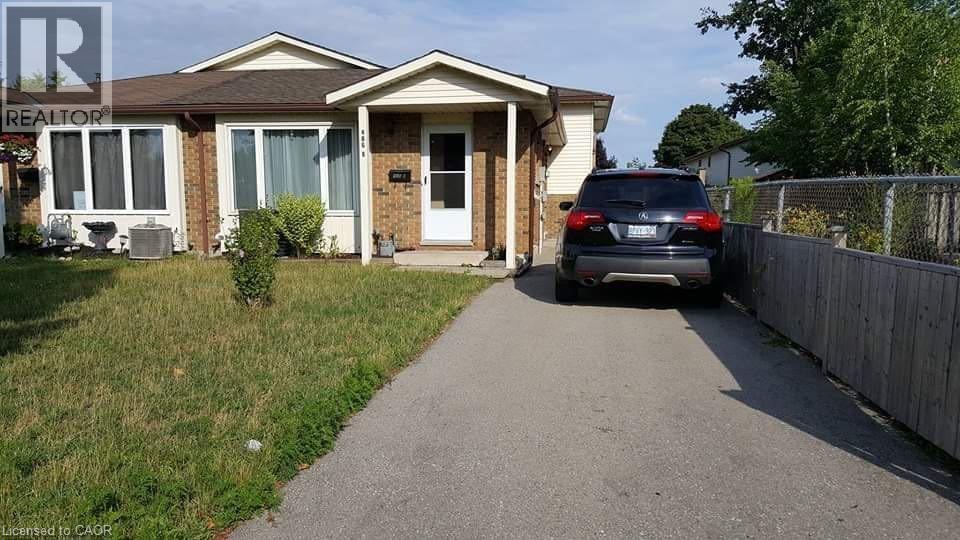 A house with a car parked in front of it.