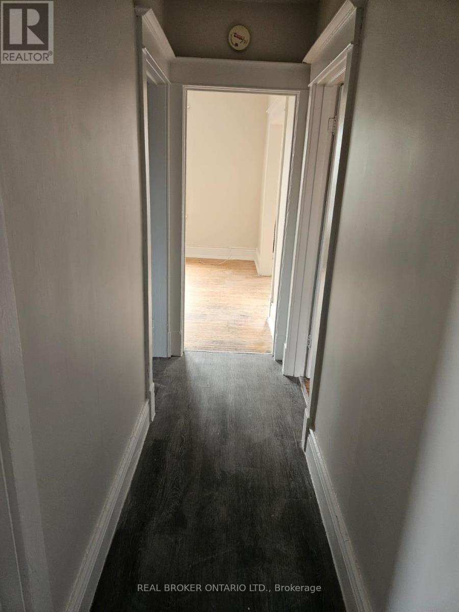 A hallway with a Real Broker Ontario Ltd. sign on the bottom.