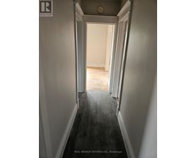 A hallway with a Real Broker Ontario Ltd. sign on the bottom.