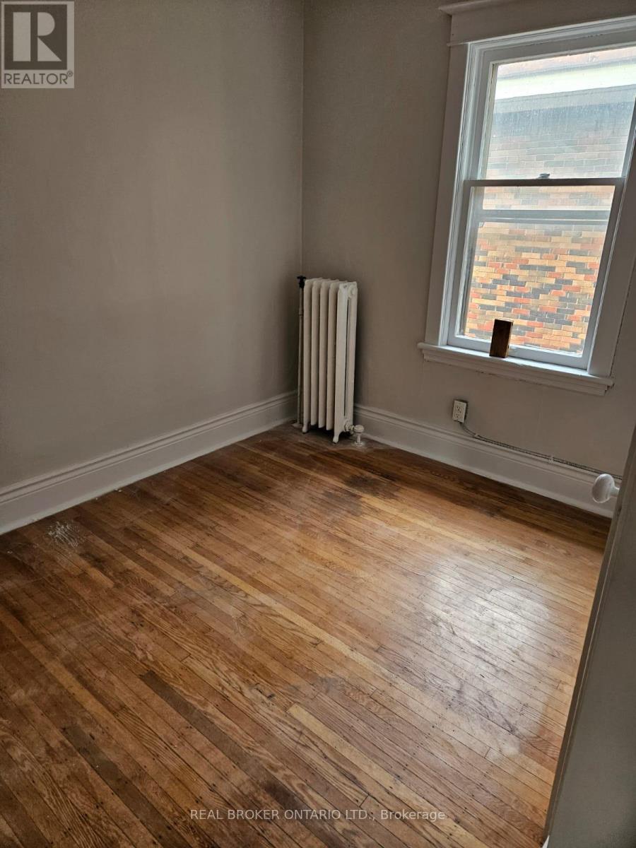 A room with a window and a radiator on the wall.