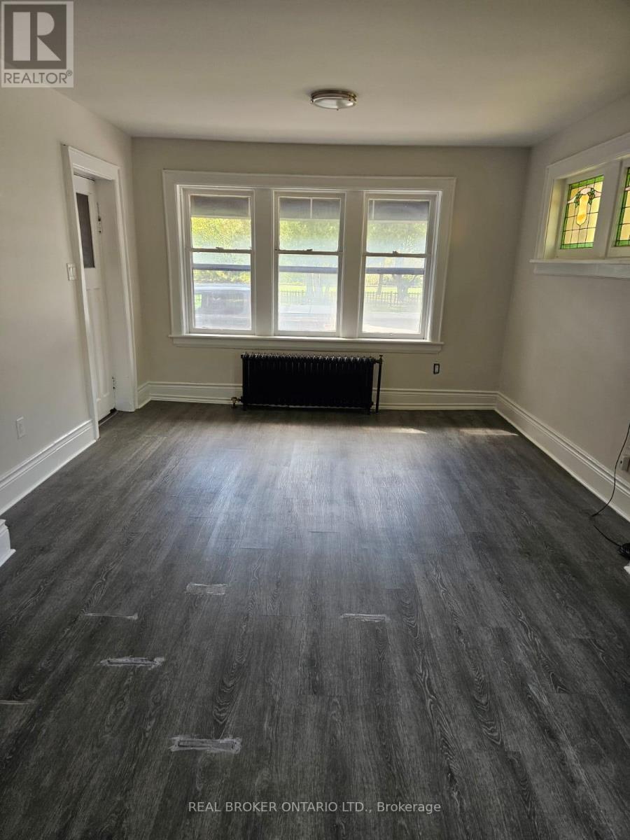 A room with wood flooring and a window.