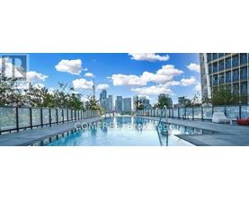 A pool on a balcony with a city skyline in the background.