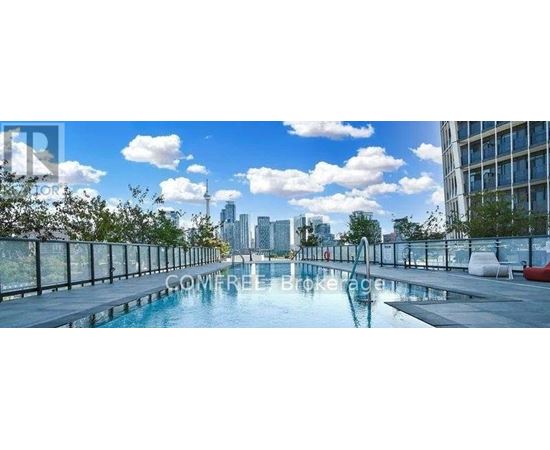 A pool on a balcony with a city skyline in the background.