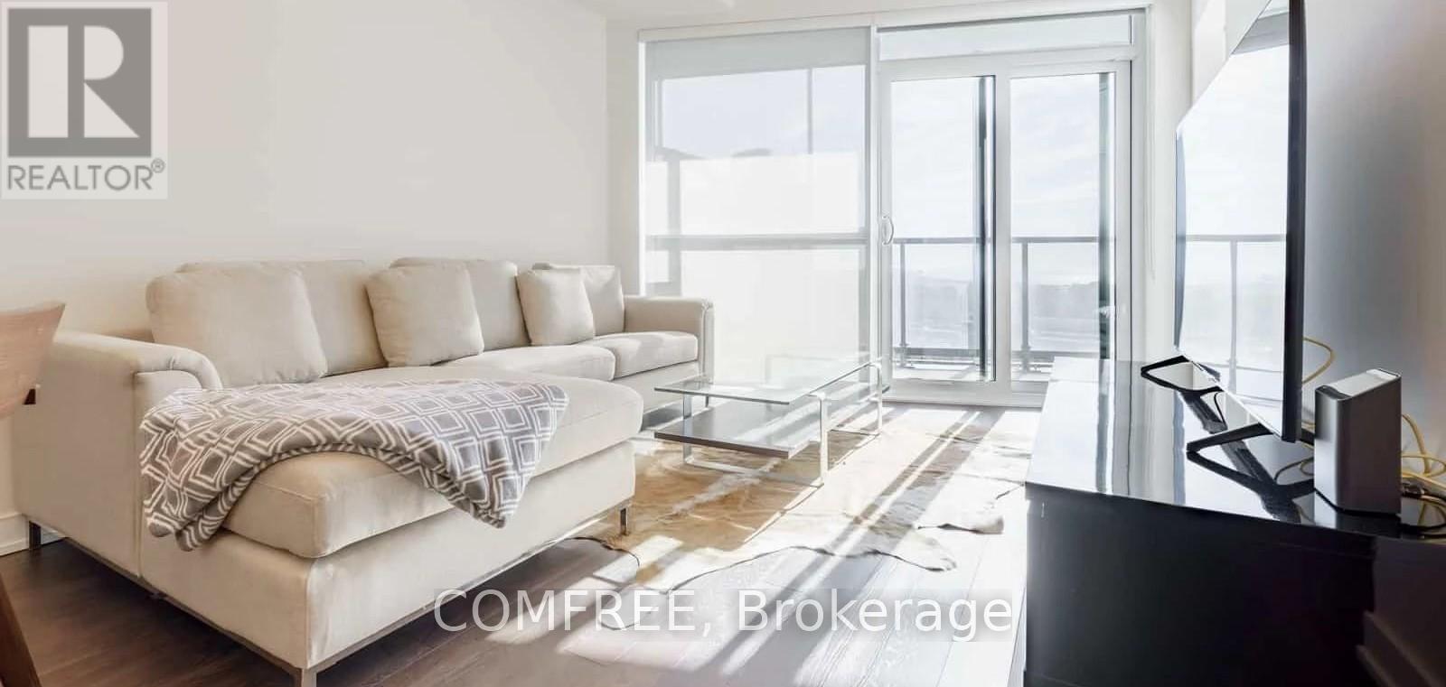A living room with a couch and a television.