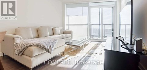 A living room with a couch and a television.