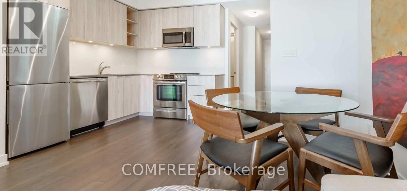 A modern kitchen with a dining table and chairs.
