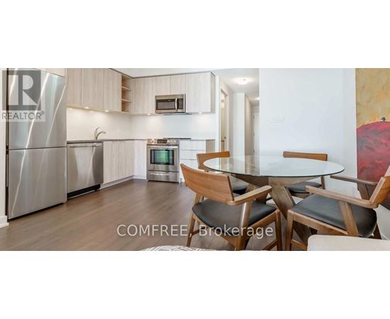A modern kitchen with a dining table and chairs.