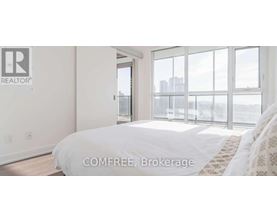 A bedroom with a large bed and a view of the city.