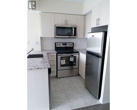 A kitchen with a stove, oven, microwave, and refrigerator.
