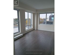 A room with a large window and a wooden floor.