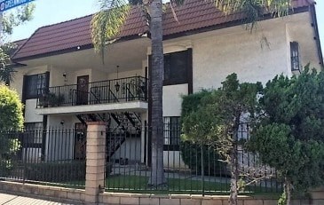 A house with a red roof and a balcony.