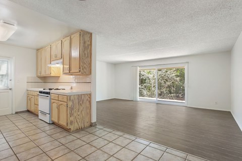 A kitchen with wooden cabinets and a white stove top oven.