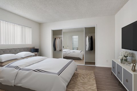 A bedroom with two beds and a large mirror.