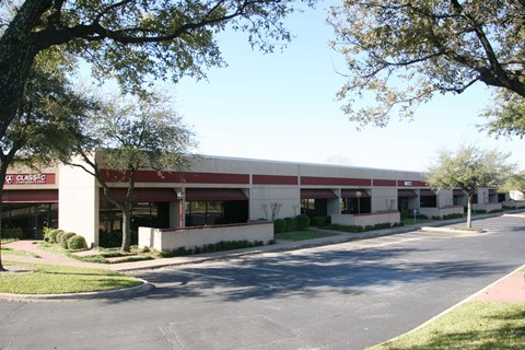 A building with the word "Classic" on it is surrounded by trees.