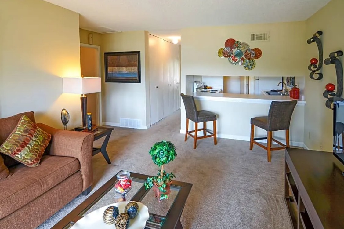 A living room with a couch, chairs, and a coffee table.
