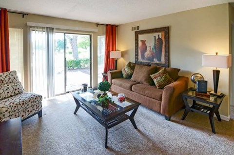 A living room with a couch, chair, and coffee table.