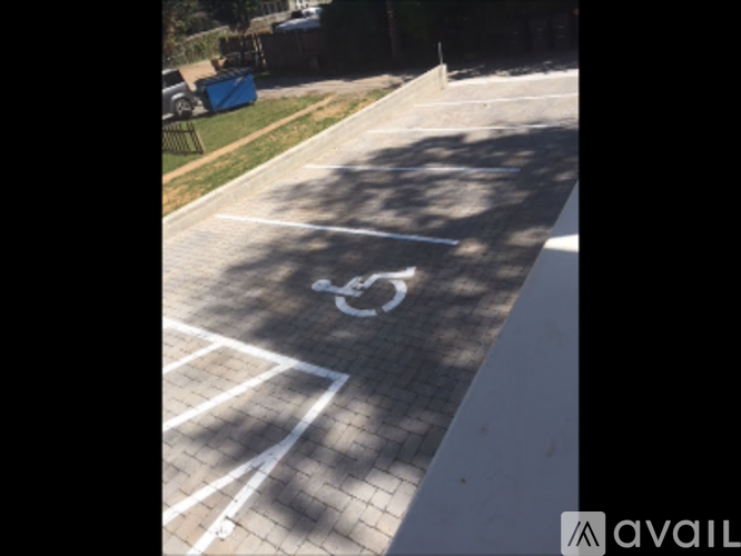 A parking lot with a white painted symbol on the pavement.