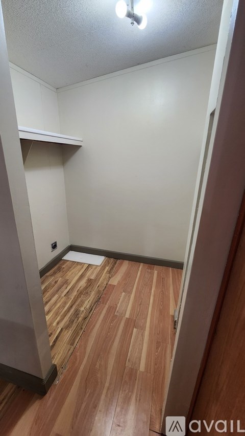 A room with wooden floors and white walls.