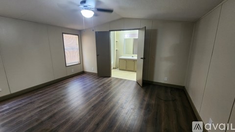 A room with wooden floors and a ceiling fan.
