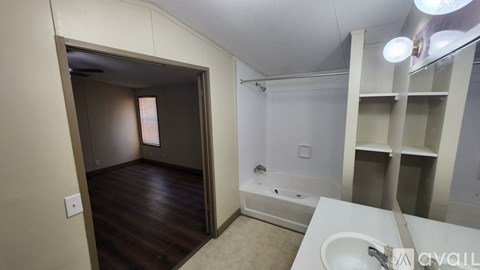 A bathroom with a white sink and a bathtub.