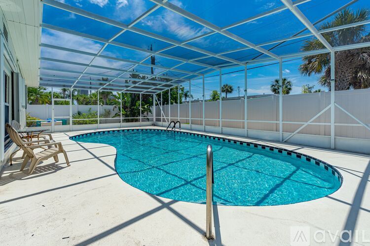 A pool under a white roof with a metal pole in the middle.