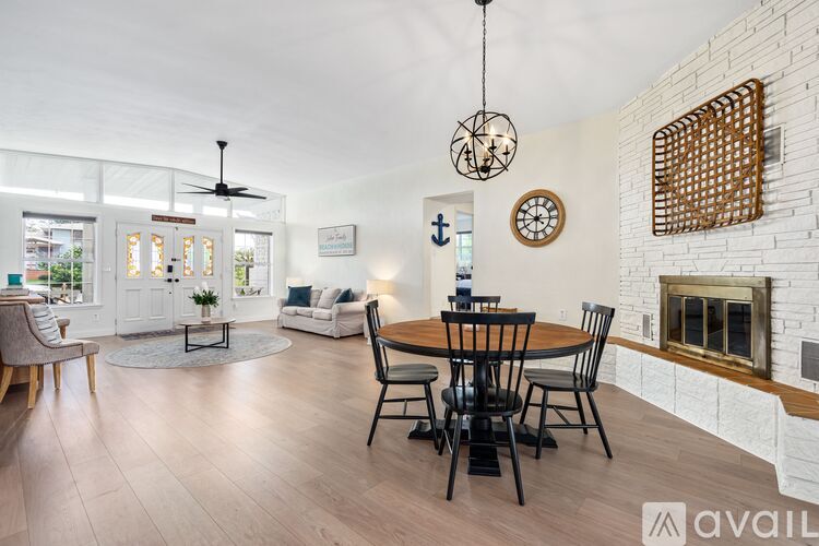 A modern dining room with a wooden table and chairs.