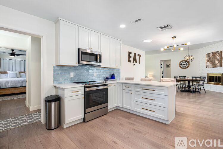 A kitchen with a large island and a microwave above it.