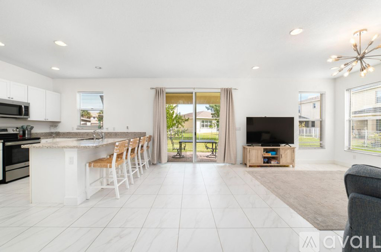 A modern kitchen with white cabinets and a large island.