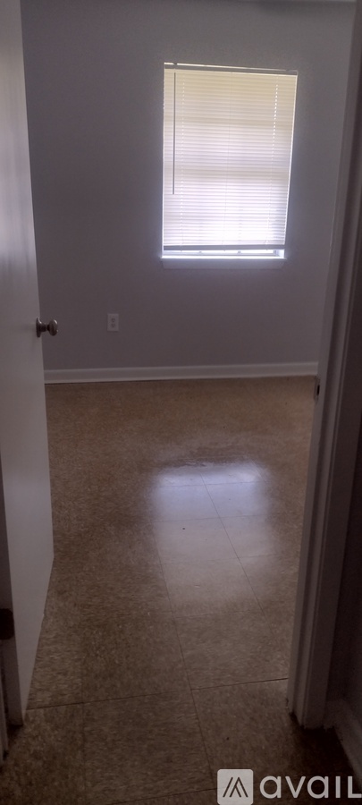 A room with a window and a door.