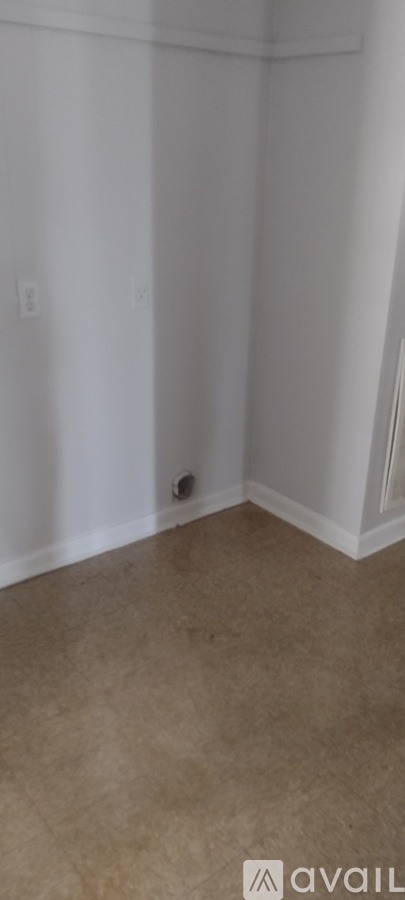 A room with white walls and a beige carpet.