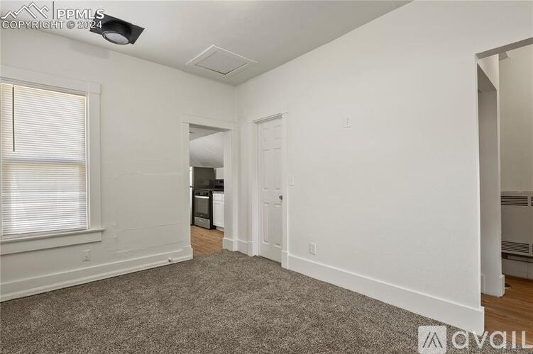 A room with white walls and a carpeted floor.