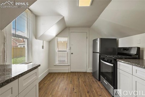 A kitchen with a stove top oven and microwave.