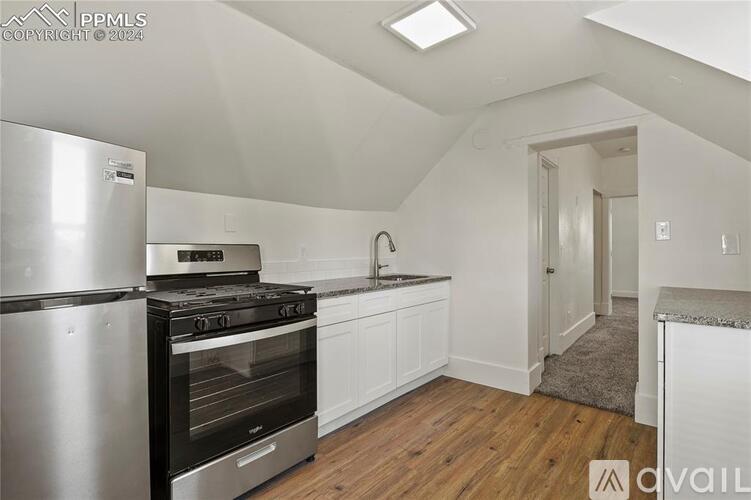 A kitchen with a stove, oven, and sink.