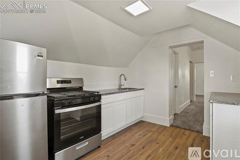 A kitchen with a stove, oven, and sink.