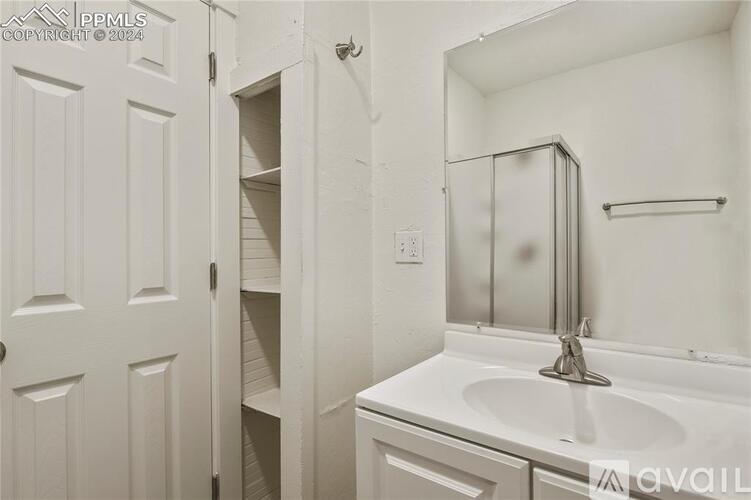 A white bathroom with a sink, mirror, and medicine cabinet.