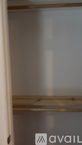 A white refrigerator with a shelf inside.