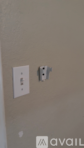 A white electrical outlet with a white switch.