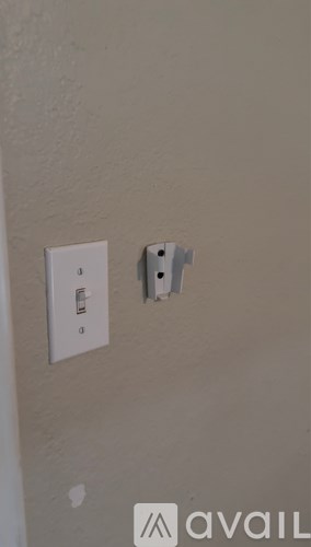 A white electrical outlet with a white switch.