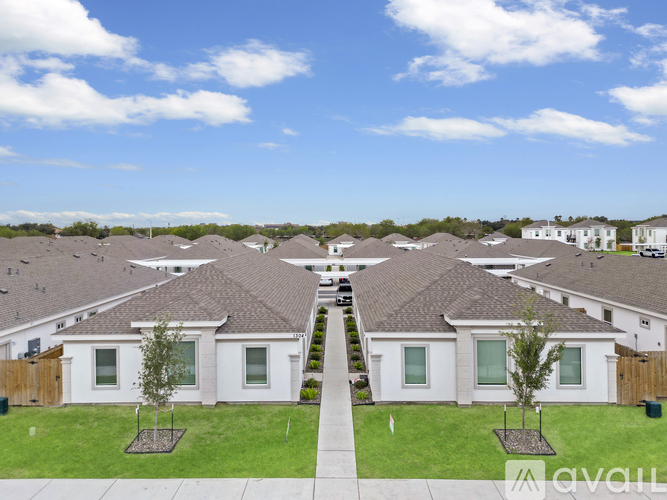 A row of houses with a clear blue sky above them.