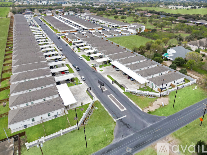 A bird's eye view of a residential area with houses and a road.