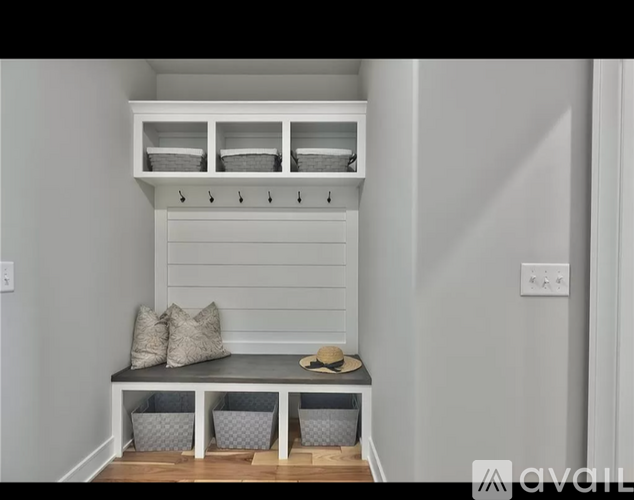 A bench with storage space above it and two baskets below.