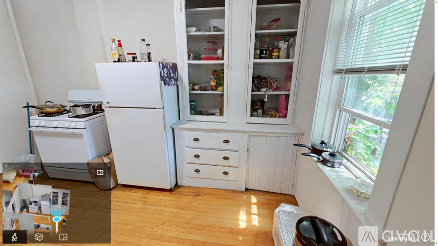 A white refrigerator with a glass door is in a kitchen.