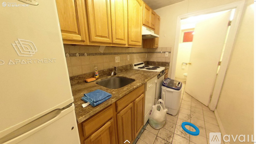 A kitchen with wooden cabinets and a white fridge.