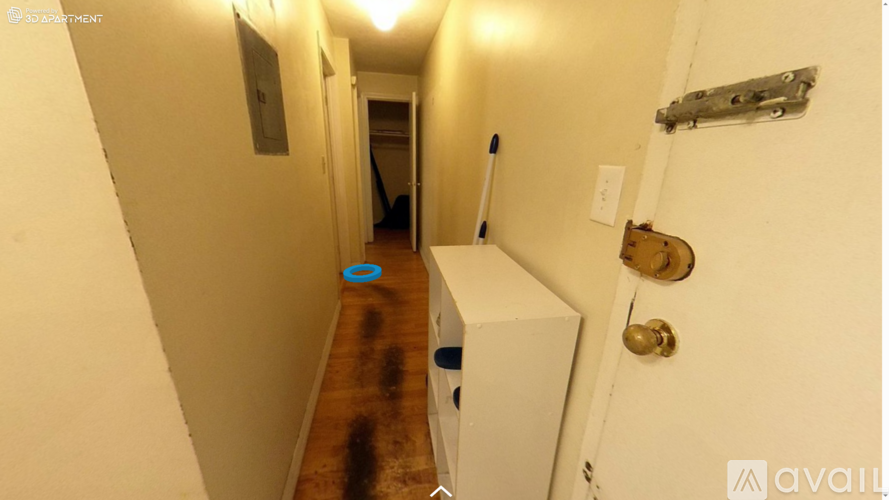 A hallway with a white door and a white cabinet.