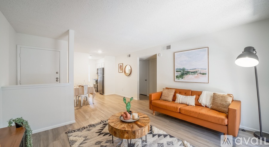 A living room with a brown couch and a coffee table in the center.